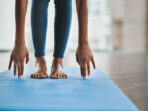 Shot of an unrecognisable woman practicing a yoga routine at home